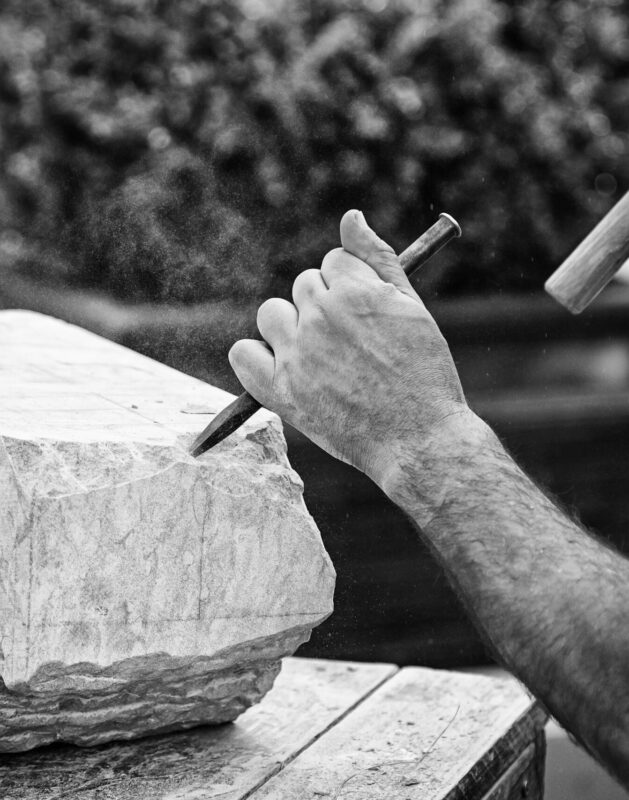 Carving stone, craftsman shaping stone, art and crafts